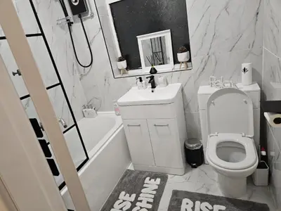 a bathroom with a toilet and a sink and a shower at Number 1 Preston Stays in Preston