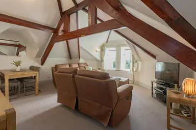 a living room with a couch and a tv at Stonyhurst Spacious apartment, great location. in Clitheroe