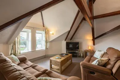 a living room with two couches and a tv at Stonyhurst Spacious apartment, great location. in Clitheroe