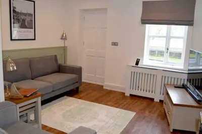 a living room with a couch and a window at Riverside House Lancaster - 2 bedroom house in Lancaster