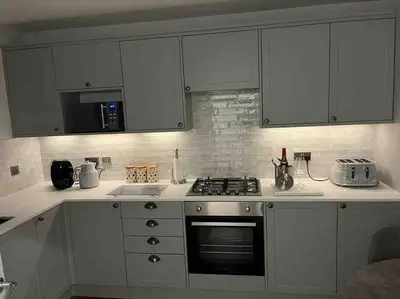 a kitchen with white cabinets and a stove top oven at Riverside House Lancaster - 2 bedroom house in Lancaster