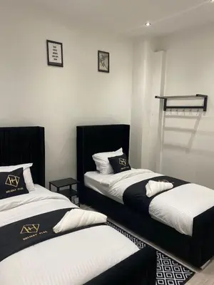 two beds sitting in a room at Holiday Plus - Palatine Road in Blackpool