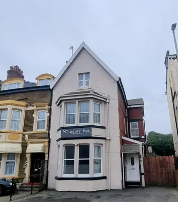 a white house with a sign on the front of it at Number twenty five in Blackpool