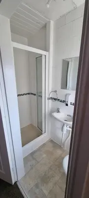 a bathroom with a shower and a toilet and a sink at Number twenty five in Blackpool