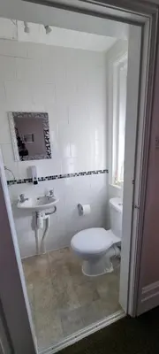 a white bathroom with a toilet and a sink at Number twenty five in Blackpool