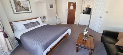 a bedroom with a bed and a table and a couch at Number twenty five in Blackpool