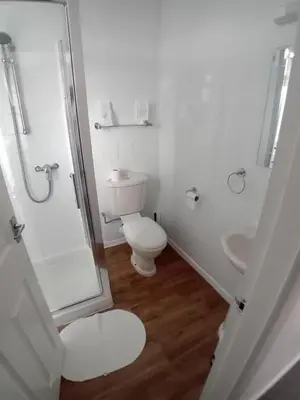 a bathroom with a toilet and a shower and a sink at Number twenty five in Blackpool