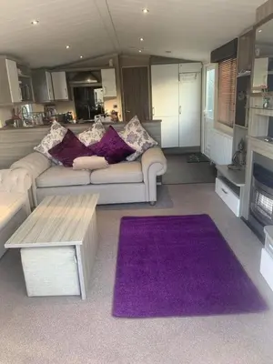 a living room with a couch and a purple rug at Haven Lakeland 3 Bed Luxury Caravan in Flookburgh