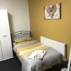 a small bedroom with a bed in the corner at Mr smiths/ The old Stanley arms in Liverpool