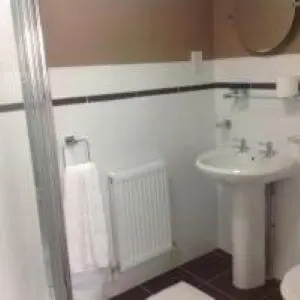 a white bathroom with a sink and a toilet at Mr smiths/ The old Stanley arms in Liverpool