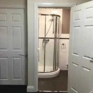 a bathroom with a shower and a white door at Mr smiths/ The old Stanley arms in Liverpool