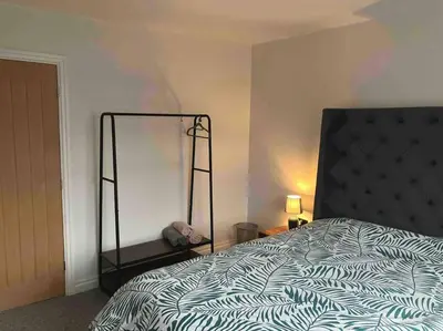 a bedroom with a bed and a mirror on the wall at Newly renovated, modern bungalow - quiet location in Lytham St Annes