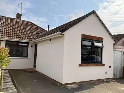 a white house with a car in the window at Newly renovated, modern bungalow - quiet location in Lytham St Annes