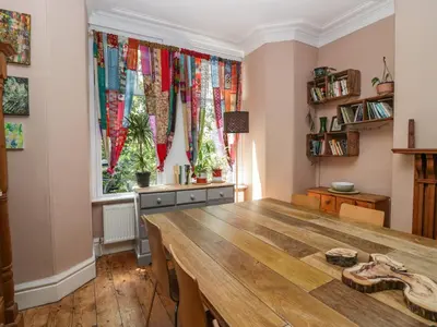 a room with a table and a window with curtains at Sunnycote in Carnforth
