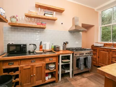 a kitchen with a stove and a microwave at Sunnycote in Carnforth