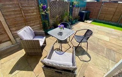 a patio with a table and chairs on a patio at Eden Stay in Morecambe
