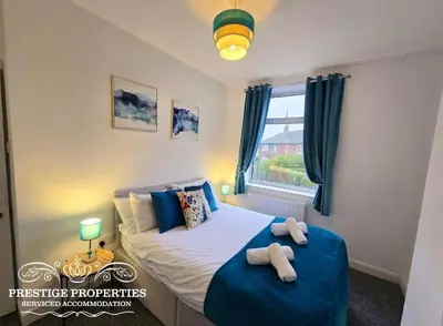 a bedroom with a bed with two towels on it at 8 Suffolk street by Prestige Properties SA in Barrow in Furness