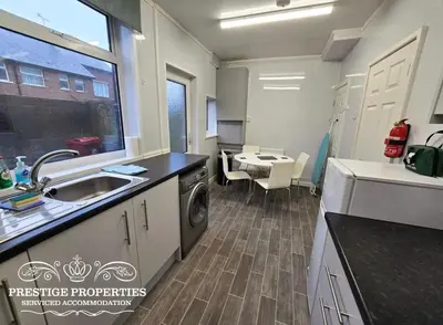 a kitchen with a sink and a washing machine at 8 Suffolk street by Prestige Properties SA in Barrow in Furness