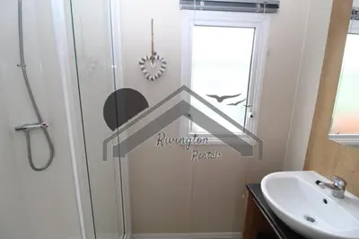 a bathroom with a shower and a sink at Serenity - 8 Berth 3 Bedroom Static Caravan in Heysham