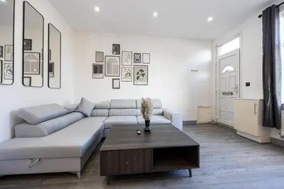 a living room with a couch and a coffee table at Deluxe Bolton Cinema House 2BR Modern Retreat with Free Parking in Bolton
