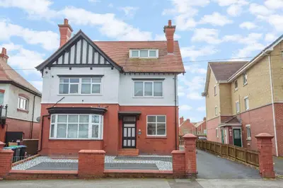a red and white house with a brick at Cherry Property - Blueberry Suite in Blackpool