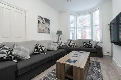 a living room with a couch and a coffee table at HORNSEY LODGE - Strictly NO Parties in Liverpool