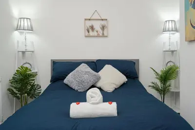 a blue bed with two pillows and a towel on it at HORNSEY LODGE - Strictly NO Parties in Liverpool