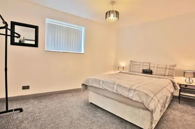 a bedroom with a bed and a window at Freckleton House in Town Centre, near Blackpool, Sleeps 6, Free Parking - By NMB Property in Kirkham
