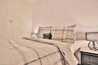 a bedroom with a bed with a teddy bear on it at Freckleton House in Town Centre, near Blackpool, Sleeps 6, Free Parking - By NMB Property in Kirkham