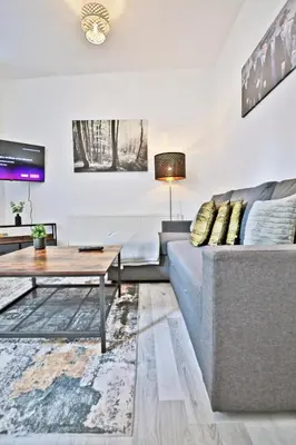 a living room with a couch and a table at Freckleton House in Town Centre, near Blackpool, Sleeps 6, Free Parking - By NMB Property in Kirkham