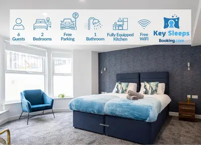a bedroom with a bed and a blue chair at Morecambe Bay Free Parking Beach Front in Morecambe