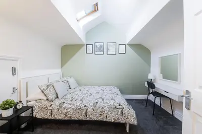 a bedroom with a bed and a desk at Poppy's Project - July Road in Liverpool
