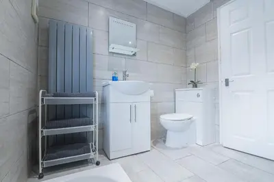 a bathroom with a toilet and a sink at Poppy's Project - July Road in Liverpool