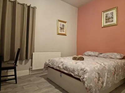 a bedroom with a bed and a desk and a laptop at ArklesFCLiverpool in Liverpool