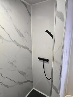 a shower in a bathroom with white marble at ArklesFCLiverpool in Liverpool