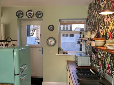 a kitchen with a green refrigerator and a window at Historical Village Cottage - Pet Friendly in Heysham