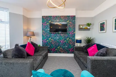 a living room with two couches and a tv at Stylish Seafront Apartment - Sleeps 6 - Gateway to the Lakes in Morecambe