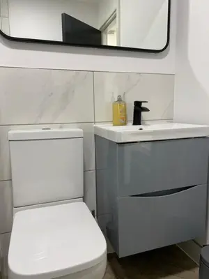 a bathroom with a toilet and a sink and a mirror at Stylish Apartments near the sea front at Morecambe in Heysham