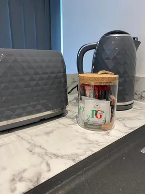 a kitchen counter with a toaster and a can of food at Stylish Apartments near the sea front at Morecambe in Heysham