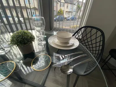 a glass table with a bowl and a plate on it at Stylish Apartments near the sea front at Morecambe in Heysham