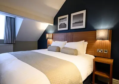 a bedroom with a large white bed with two pillows at The County Hotel by Innkeeper's Collection in Lytham St Annes