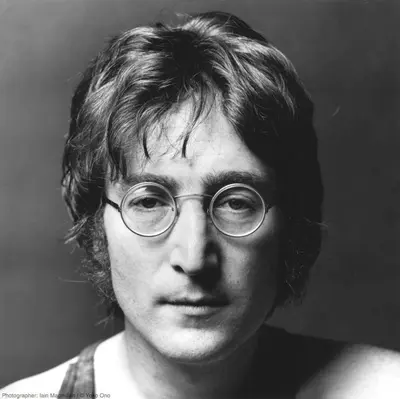 a man with glasses is posing for a picture at Beatles Apartment in Liverpool