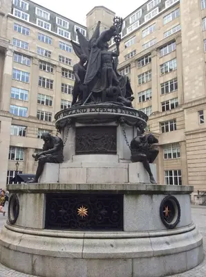a statue of a woman standing in front of a building at Beatles Apartment in Liverpool