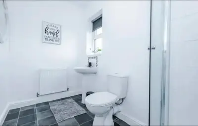 a white bathroom with a toilet and a sink at St Helens - Cosy 1 Bed in Saint Helens
