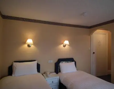 two beds sitting next to each other in a room at The North Euston Hotel in Fleetwood