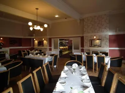 a dining room with tables and chairs and a restaurant at The North Euston Hotel in Fleetwood