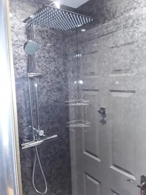 a shower with a glass door in a bathroom at no 7 boutique apartment in Ulverston