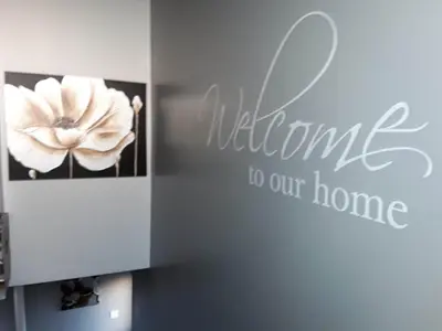 a wall with a sign that reads welcome to our home at no 7 boutique apartment in Ulverston