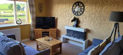 a living room with a couch and a tv at no 7 boutique apartment in Ulverston