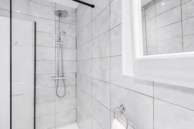 a bathroom with a shower with a glass door at HARROW LODGE - Strictly NO Parties in Liverpool